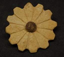 A glazed faience rosette excavated by Max Mallowan to the south of the temple of Kidmuru on Kalhu's citadel mound