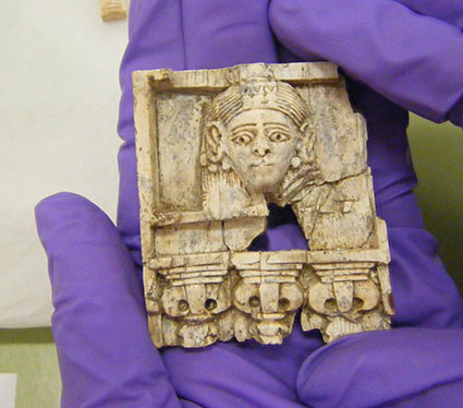 Newly cleaned carved ivory, showing a framed female face in Egyptianising style