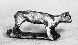 Bronze figurine of four-legged animal, which appears very cat-like but probably represents a dog